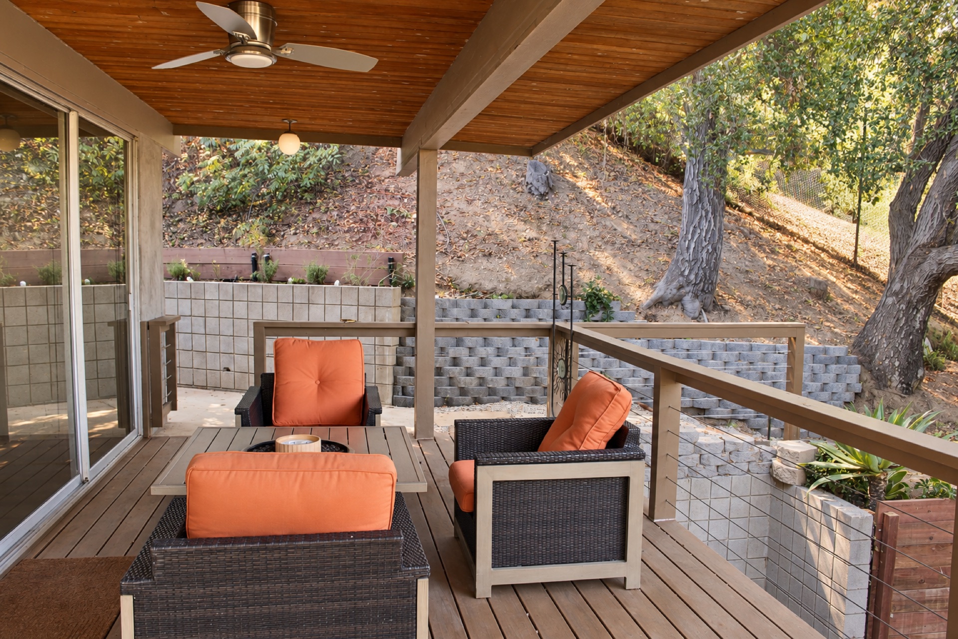Covered patio with outdoor seating and hillside views at The Gift House, Los Angeles