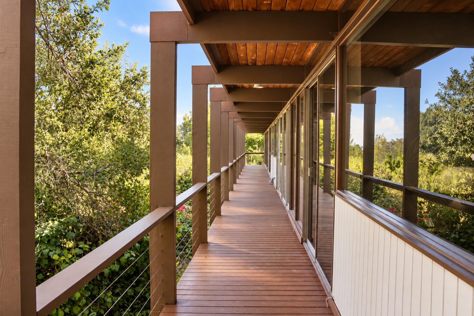 Long covered deck surrounded by mature trees at a Sherman Oaks filming location