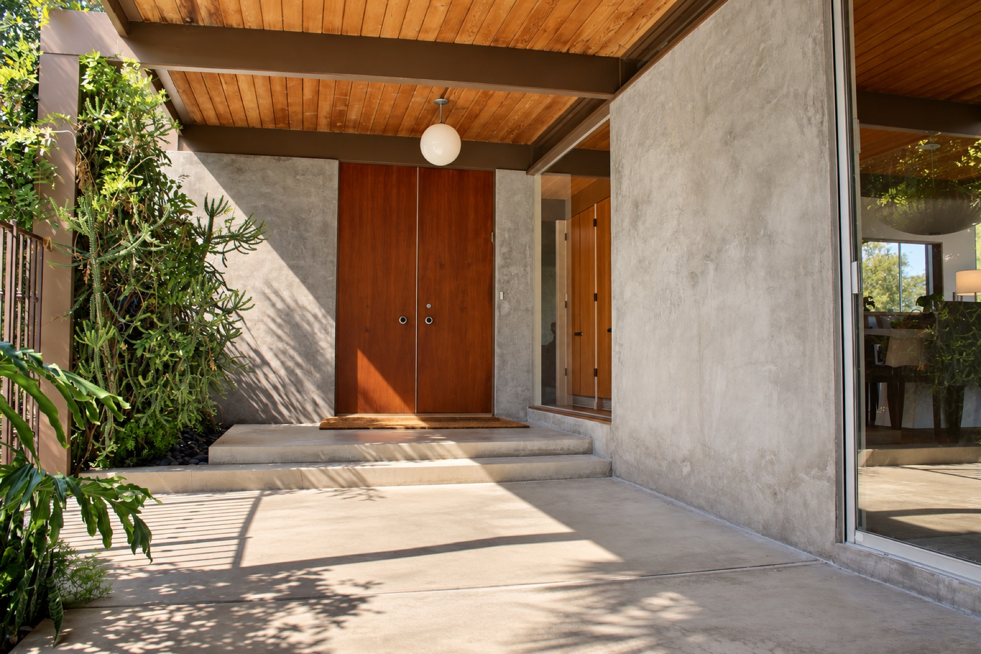 Front entry of a 1962 mid-century modern filming location in Sherman Oaks with wood double doors and concrete block