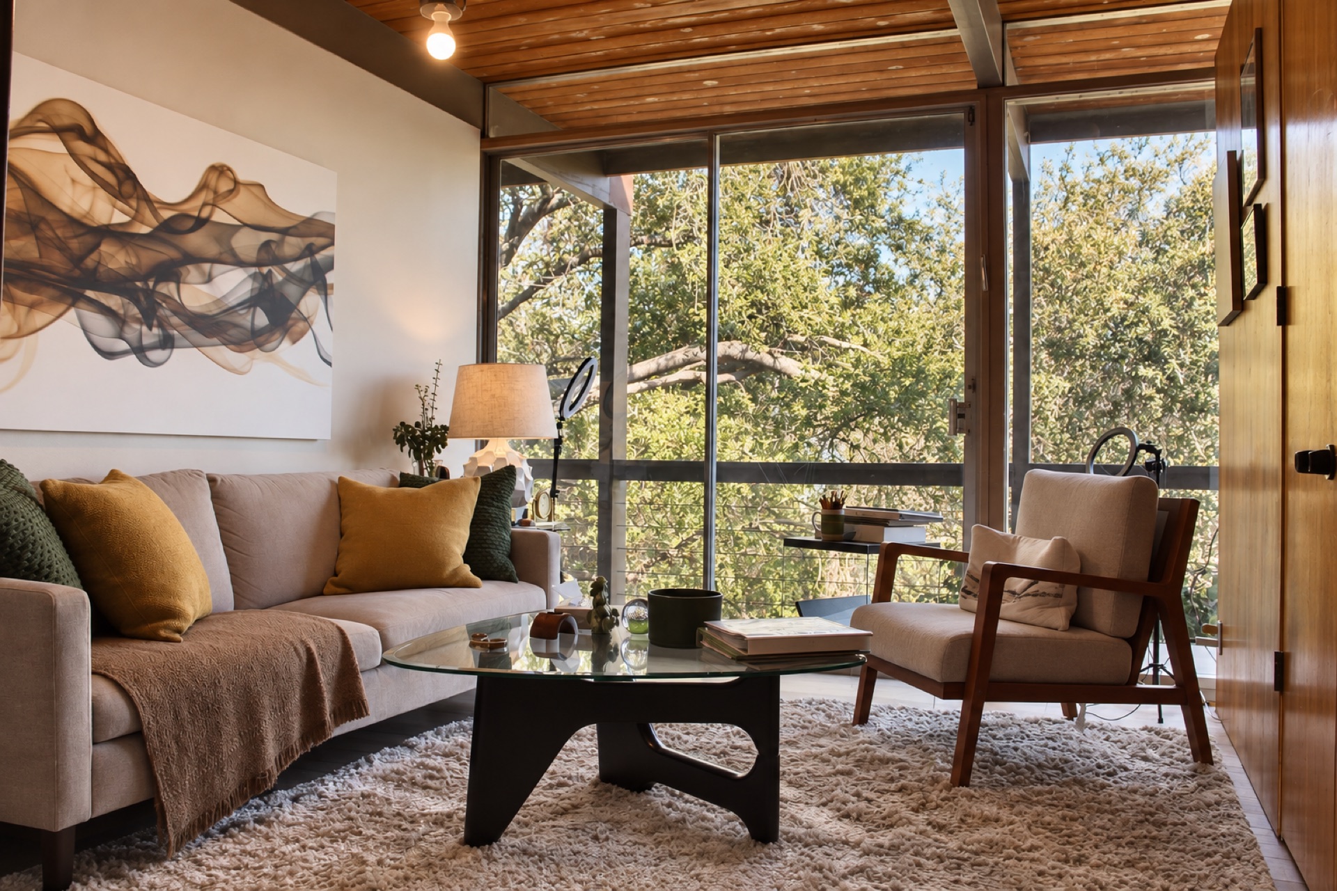 Sitting area with floor-to-ceiling windows overlooking lush garden at a mid-century home