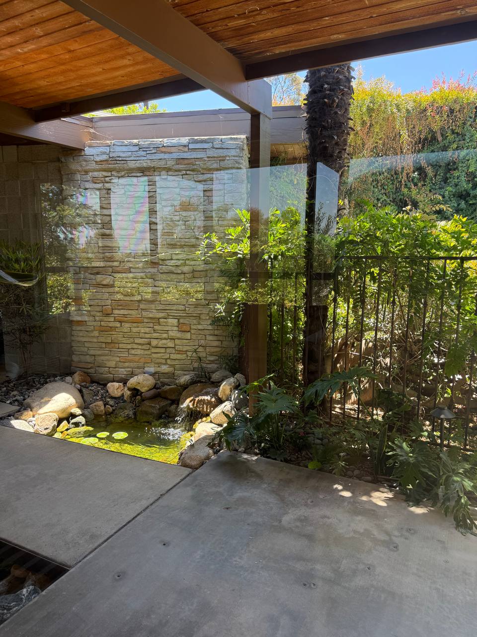 Covered patio with stone pond