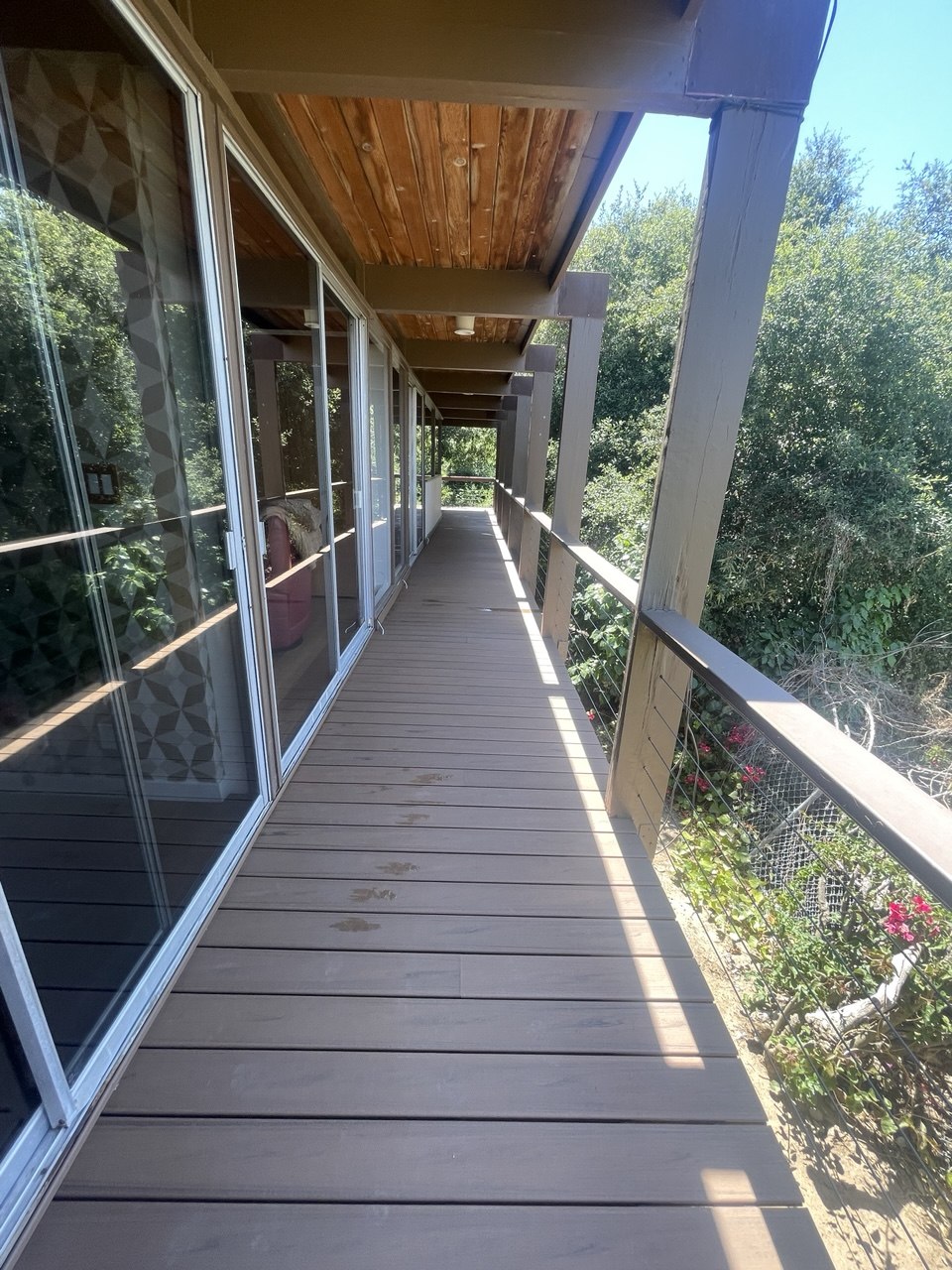 Long covered walkway with greenery